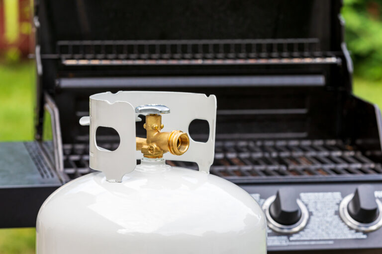 Propane tank beside an outdoor grill